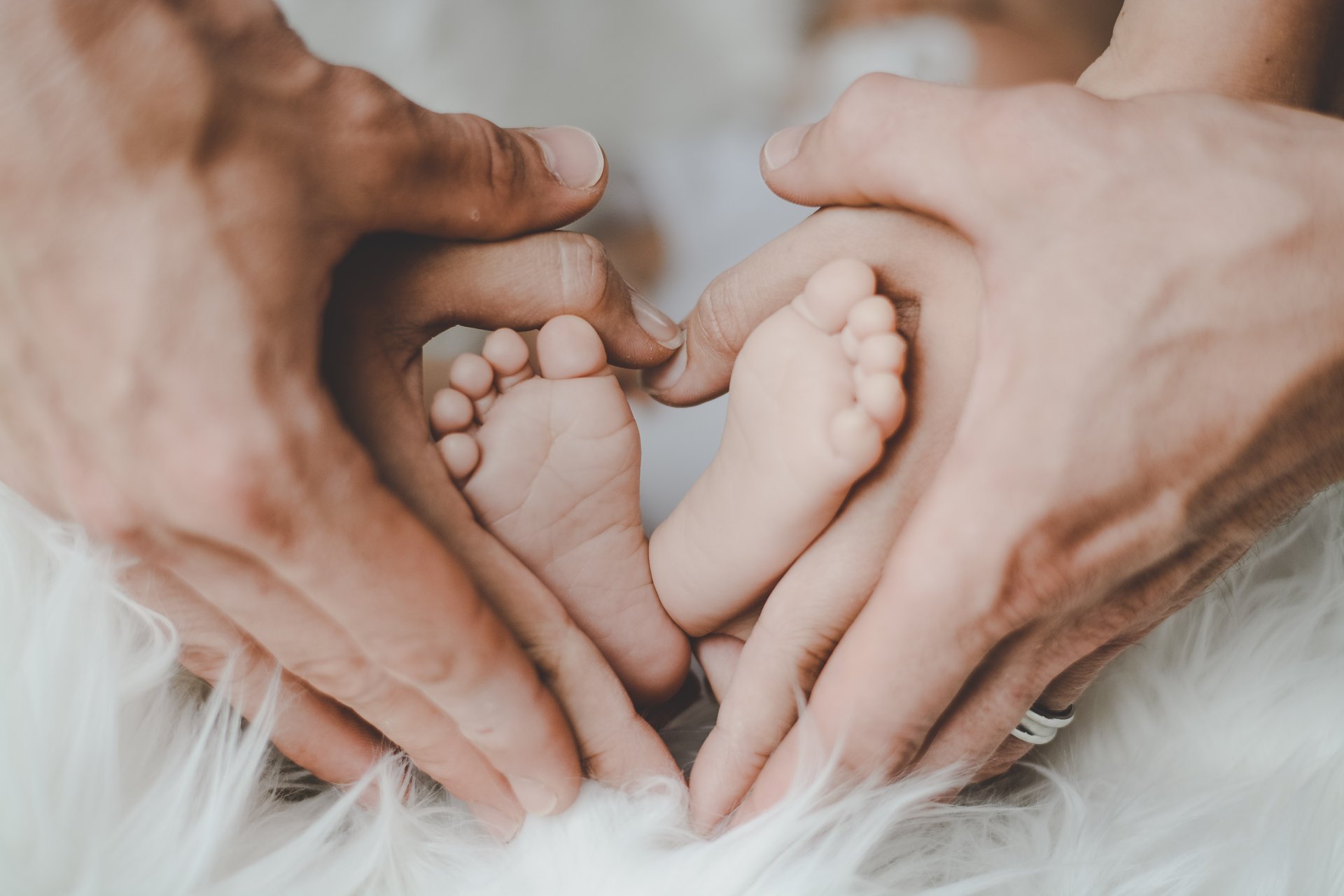 person-holding-baby-s-feet-2456327